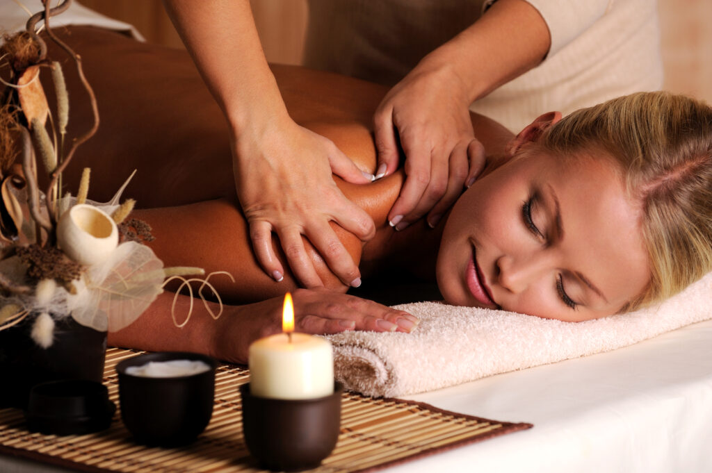 A woman is being treated at a NeuroRehab Clinic in Calgary, lying down on a massage table.