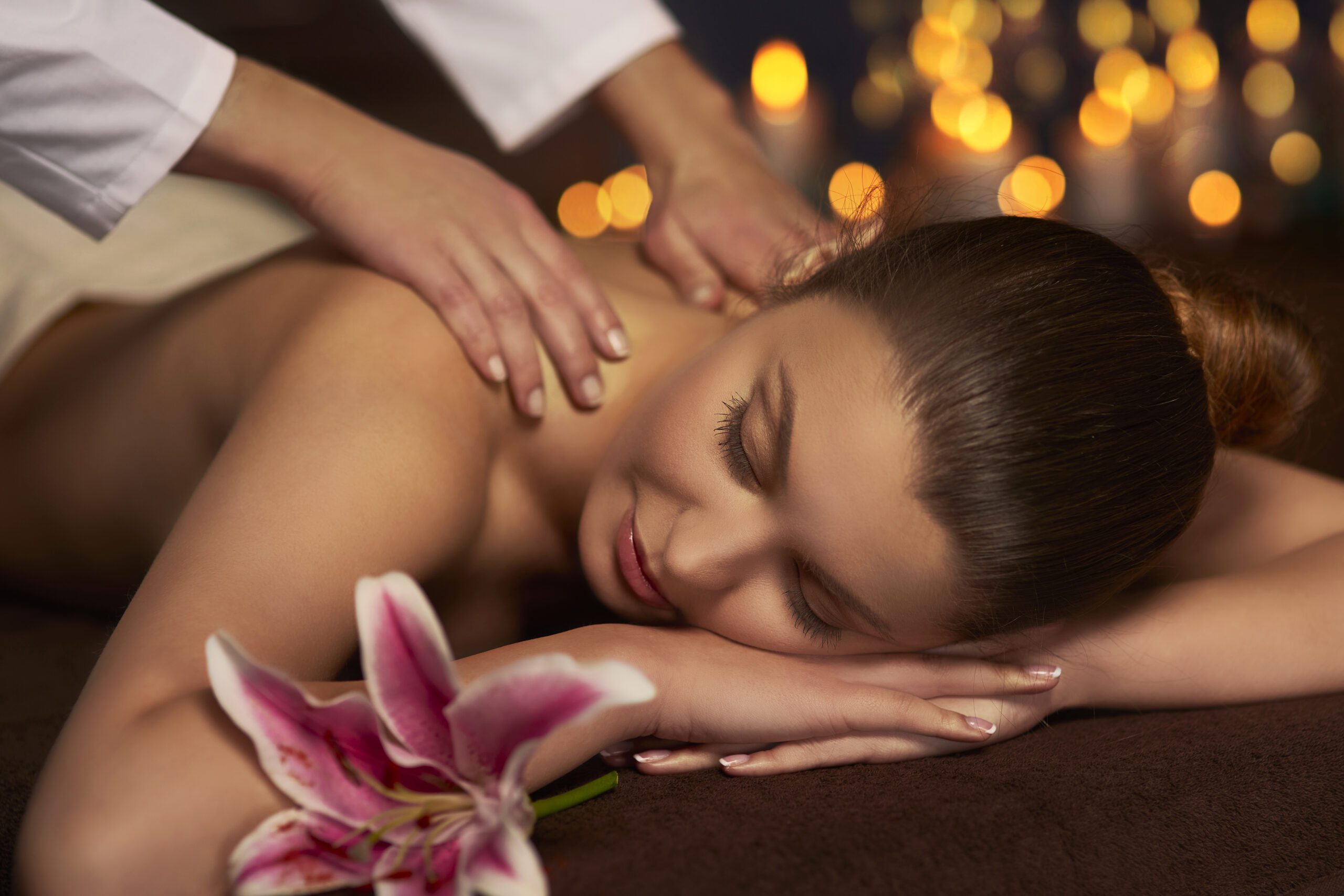 A woman enjoying a back massage at a NeuroRehab Clinic and Physiotherapy in Calgary.